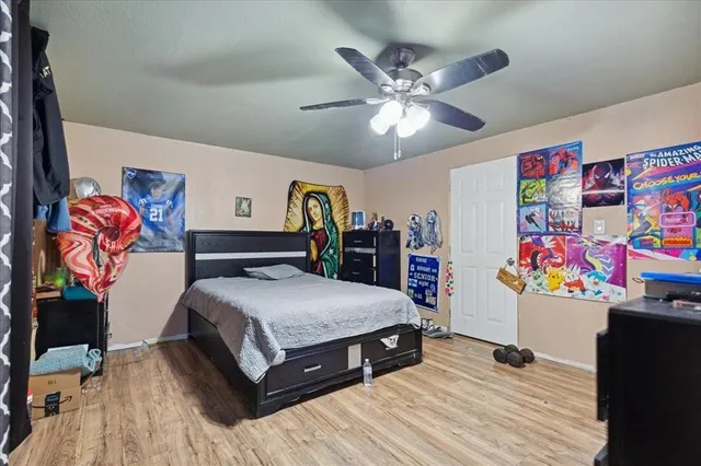 a bedroom with a bed and a chandelier