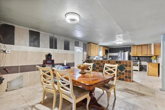 a kitchen with a refrigerator a stove a sink dishwasher and wooden cabinets
