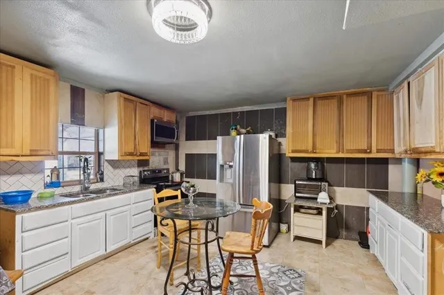 a kitchen with stainless steel appliances kitchen island granite countertop a sink and cabinets