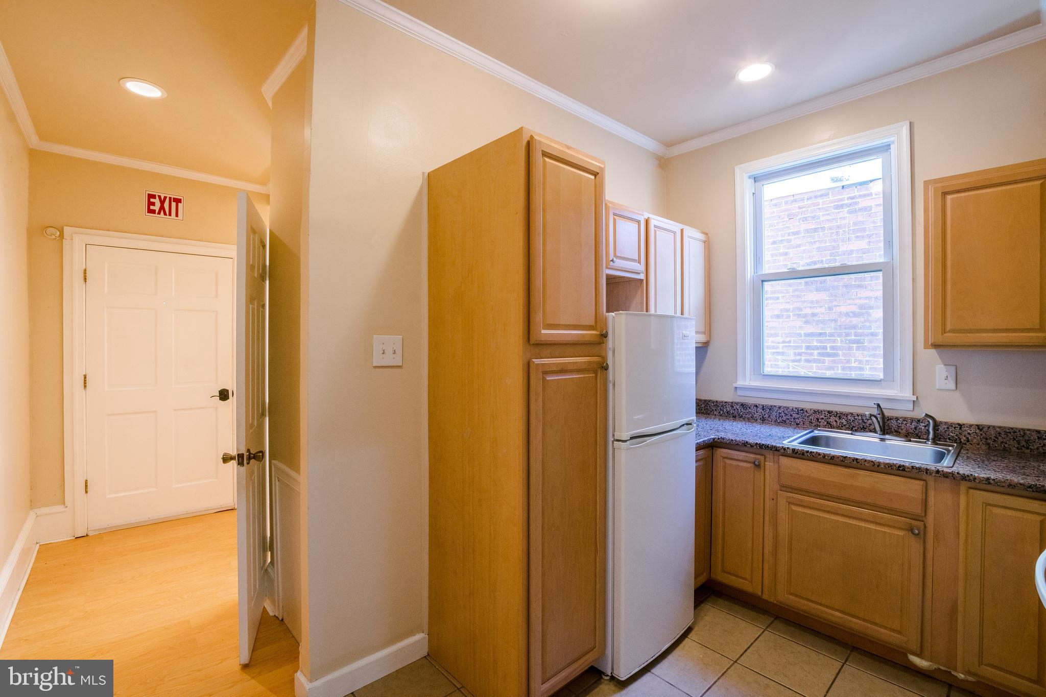 1720 Moore Street, Unit 2 Philadelphia, PA 19145 - Photo 2 of 15 a bathroom with a granite countertop sink and a mirror