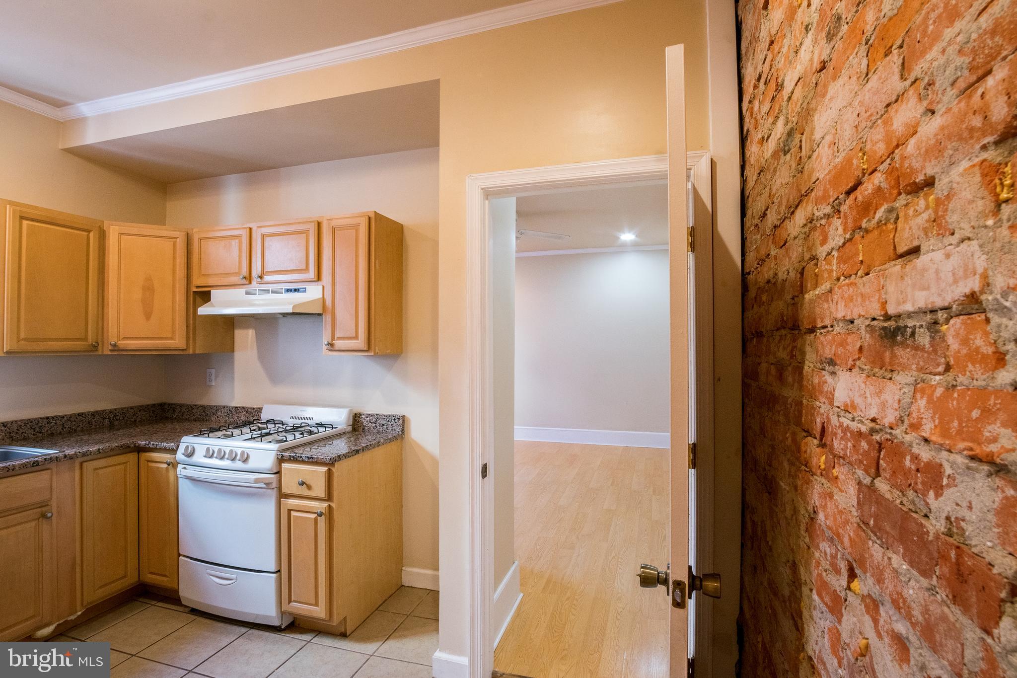 1720 Moore Street, Unit 2 Philadelphia, PA 19145 - Photo 10 of 15 a kitchen with a stove and a cabinet