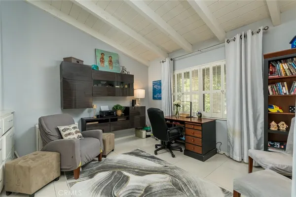 a living room with furniture fireplace and a large window