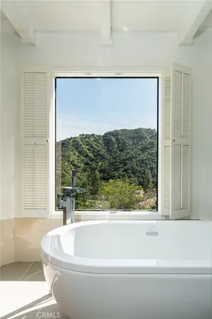 a view of a house with swimming pool and sitting area