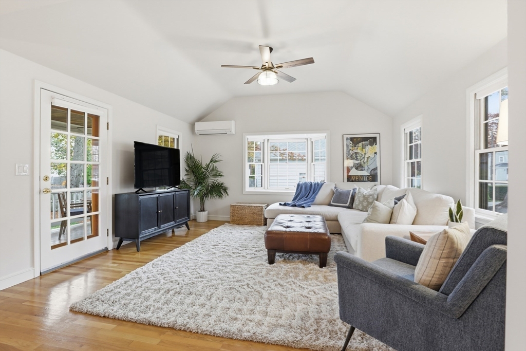 5 Sheffield Road Stoneham, MA 02180 - Photo 13 of 37 a living room with furniture a flat screen tv and a large window