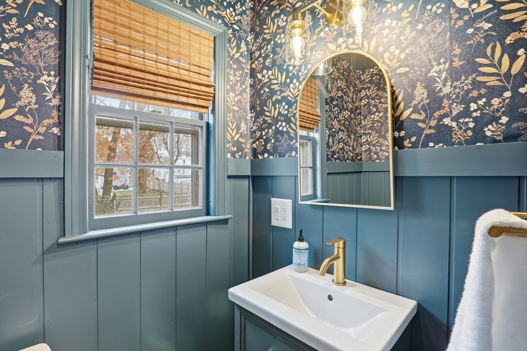 5 Sheffield Road Stoneham, MA 02180 - Photo 19 of 37 a bathroom with a sink and mirror