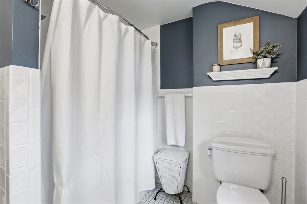 5 Sheffield Road Stoneham, MA 02180 - Photo 28 of 37 a white toilet sitting next to a white sink