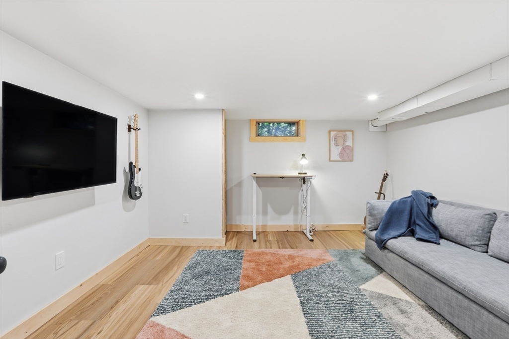 5 Sheffield Road Stoneham, MA 02180 - Photo 30 of 37 a living room with furniture and a flat screen tv
