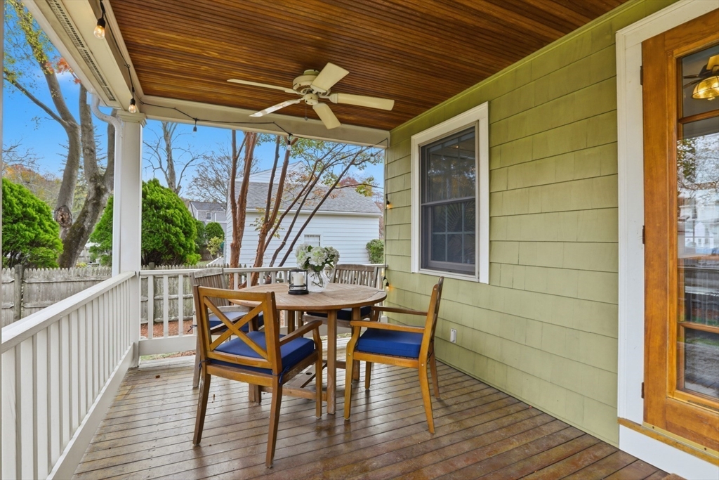 5 Sheffield Road Stoneham, MA 02180 - Photo 3 of 37 a view of a roof deck with table and chairs and wooden floor