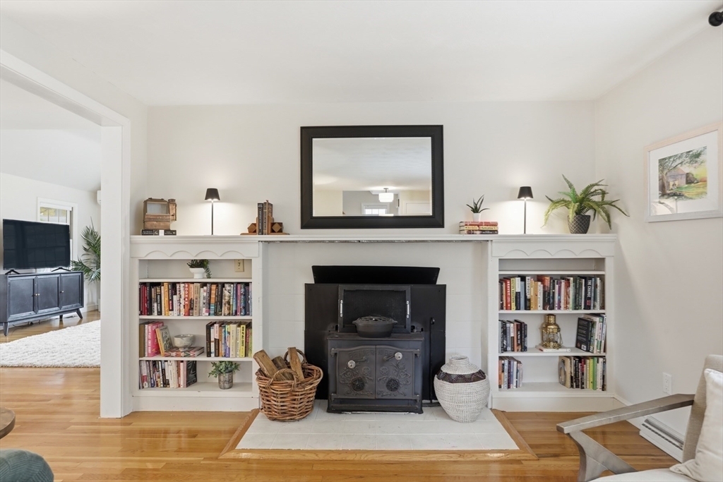 5 Sheffield Road Stoneham, MA 02180 - Photo 9 of 37 a living room with furniture and a fireplace