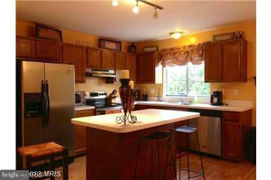 4444 Silver Teal Road Baltimore, MD 21236 - Photo 2 of 7 a kitchen with a sink refrigerator and cabinets