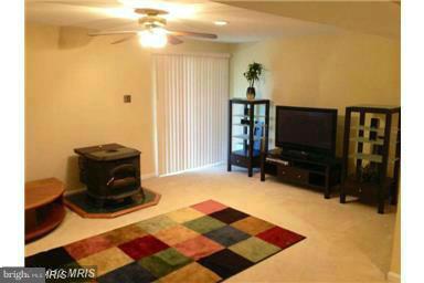 4444 Silver Teal Road Baltimore, MD 21236 - Photo 6 of 7 a living room with a rug and a flat screen tv