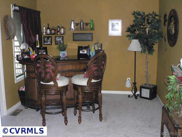 3003 Long Oaks Road Midlothian, VA 23112 - Photo 6 of 7 a view of a workspace with furniture and a fireplace