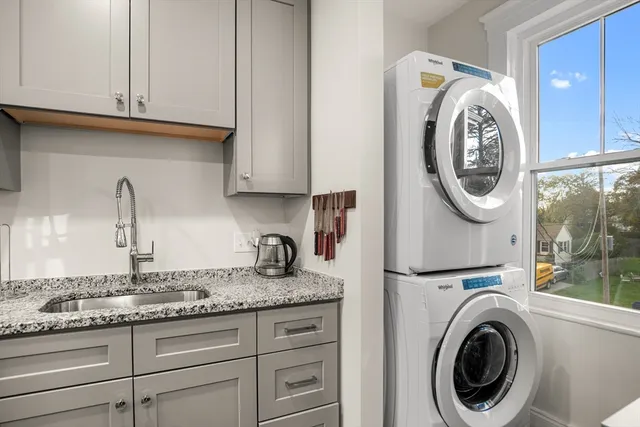 a kitchen with granite countertop a sink and a stove