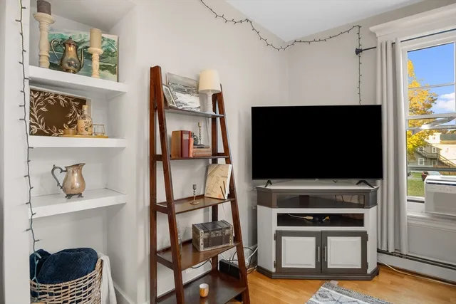 a living room with fireplace furniture and a flat screen tv