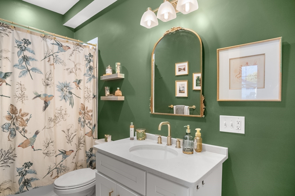 149 High Street, Unit 4 Danvers, MA 01923 - Photo 17 of 33 a bathroom with a sink mirror and toilet