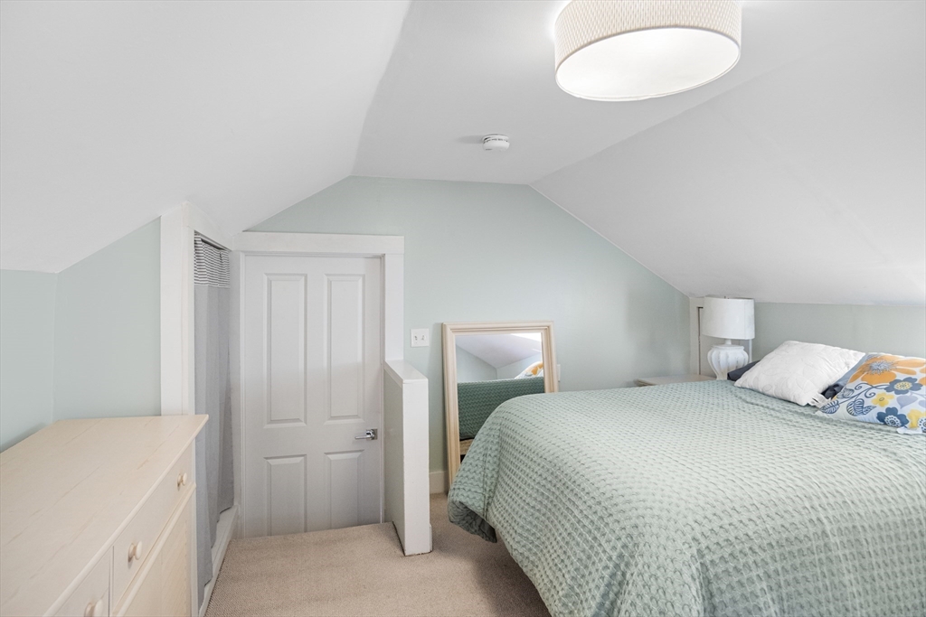 149 High Street, Unit 4 Danvers, MA 01923 - Photo 27 of 33 a bedroom with a bed and a cabinets