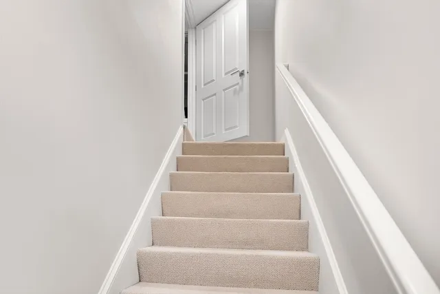 a view of staircase with white walls