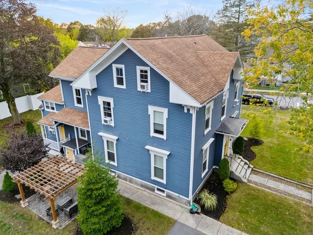 a aerial view of a house with a yard