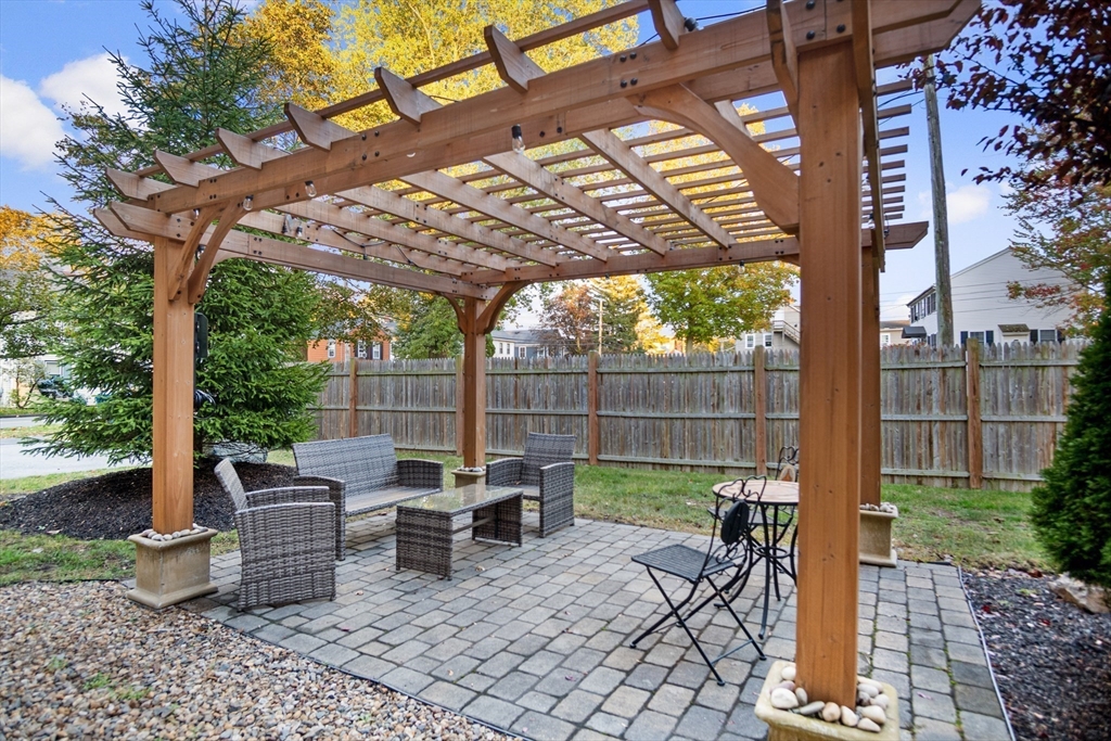 149 High Street, Unit 4 Danvers, MA 01923 - Photo 33 of 33 a view of a patio with a table chairs and a backyard