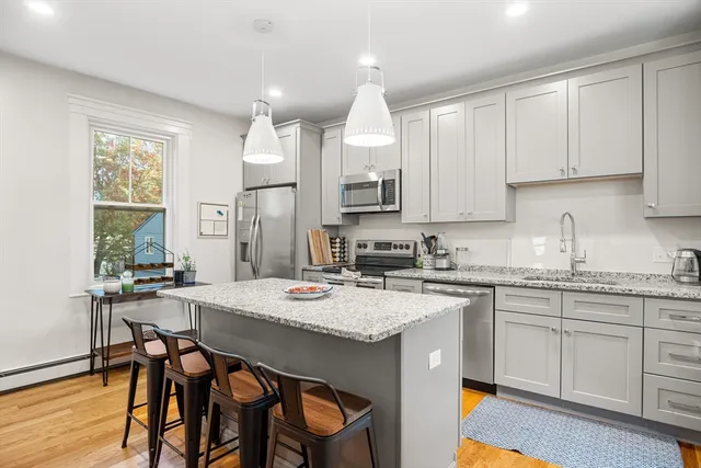 a kitchen with a table chairs sink and cabinets