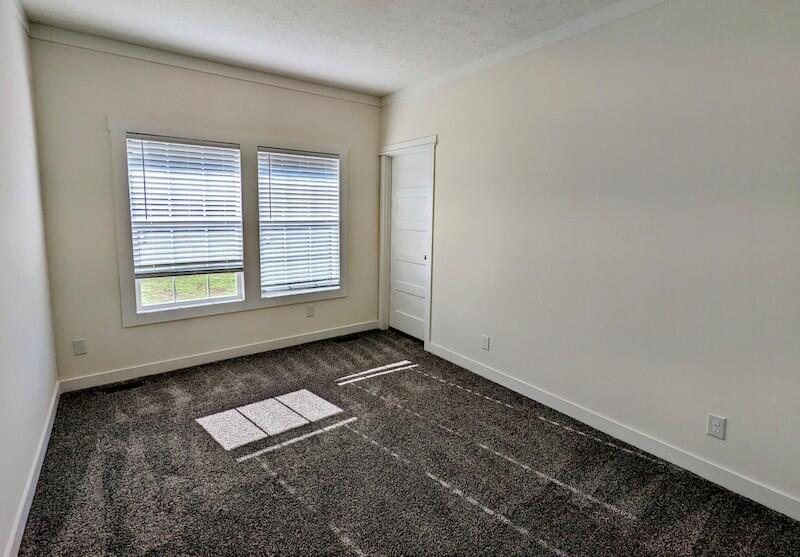 129 Long Level Road Southwest Floyd, VA 24091 - Photo 12 of 25 an empty room with wooden floor and windows