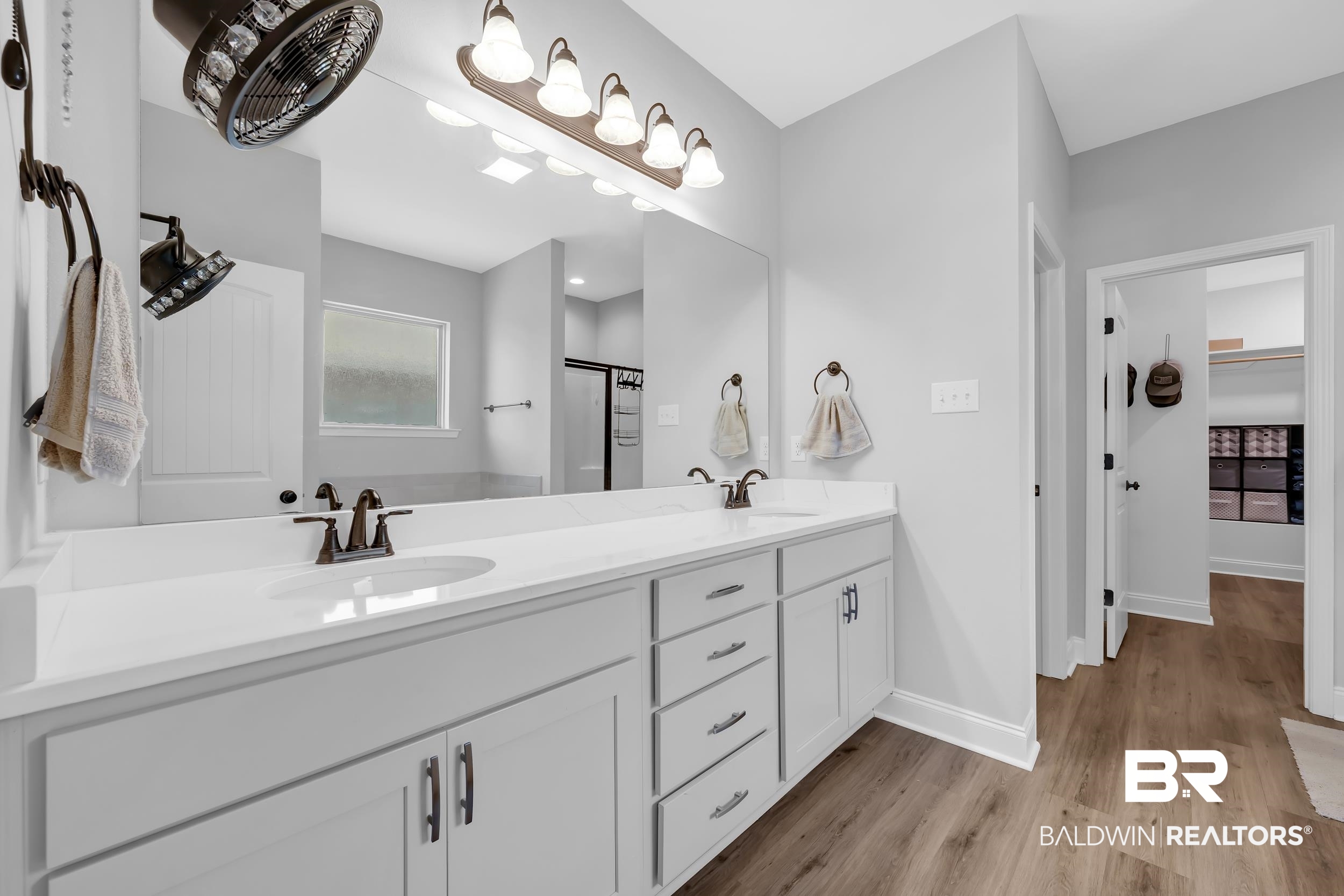 1176 Stella Road Foley, AL 36535 - Photo 20 of 40 Bathroom with double vanity, light wood-style flooring, a shower stall, and a walk in closet