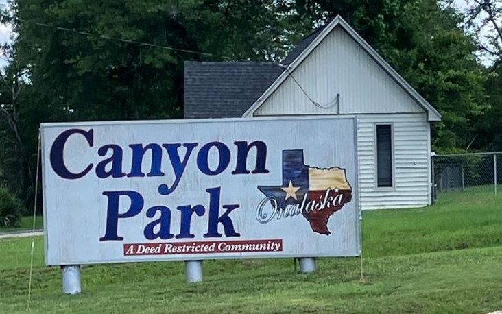 a street sign that is sitting on the green field
