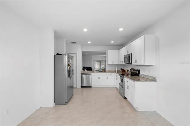 a kitchen with a refrigerator and a sink