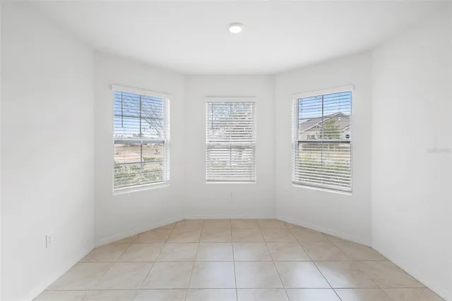 a view of a refrigerator in kitchen and a window