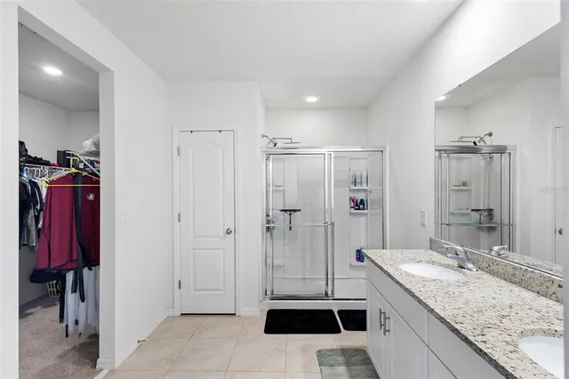 a bathroom with a granite countertop sink mirror and double