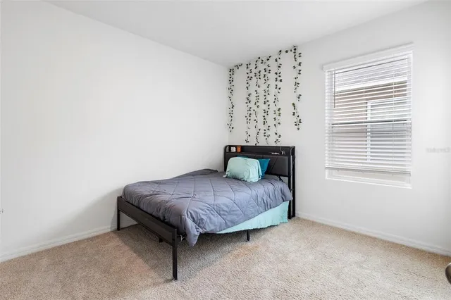 a bathroom with a granite countertop sink a toilet a mirror a bathtub and shower