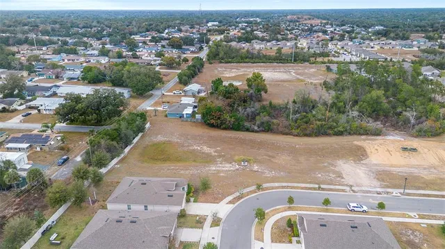 an aerial view of lake and residential houses with outdoor space