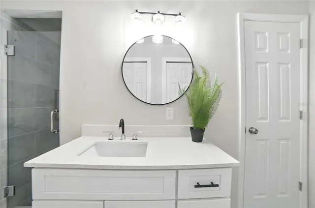 a bathroom with a sink and a mirror
