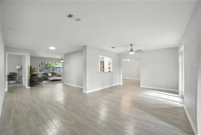 a view of a livingroom with furniture and a ceiling fan
