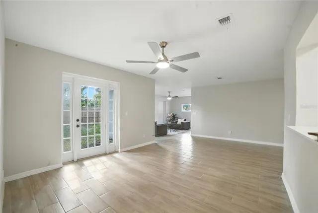 a view of a livingroom with a ceiling fan and window