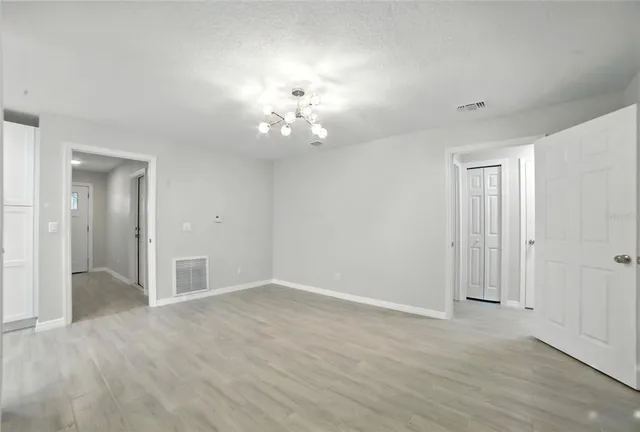 a view of an empty room with glass door