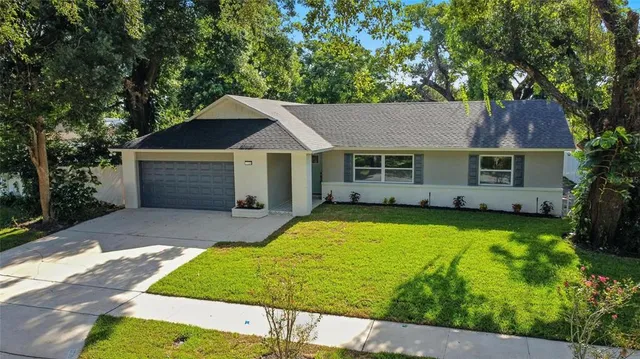 a view of a house with pool and a yard