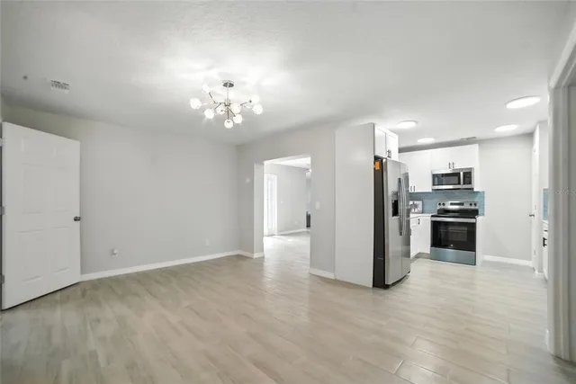 a view of a kitchen with a sink and a refrigerator