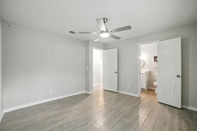 a view of an empty room and wooden floor