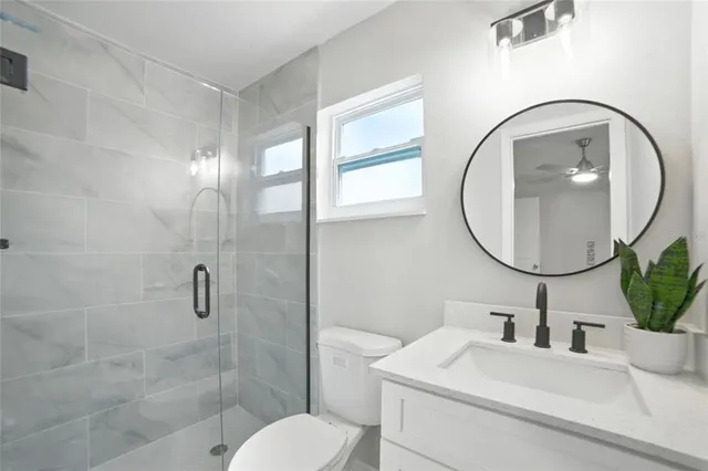 a bathroom with a sink a toilet and a mirror