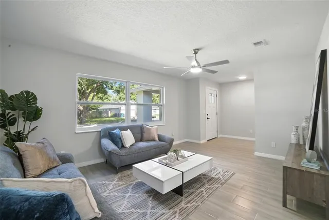 a living room with furniture and a large window