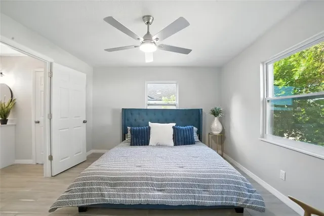 a bedroom with a large bed and a window