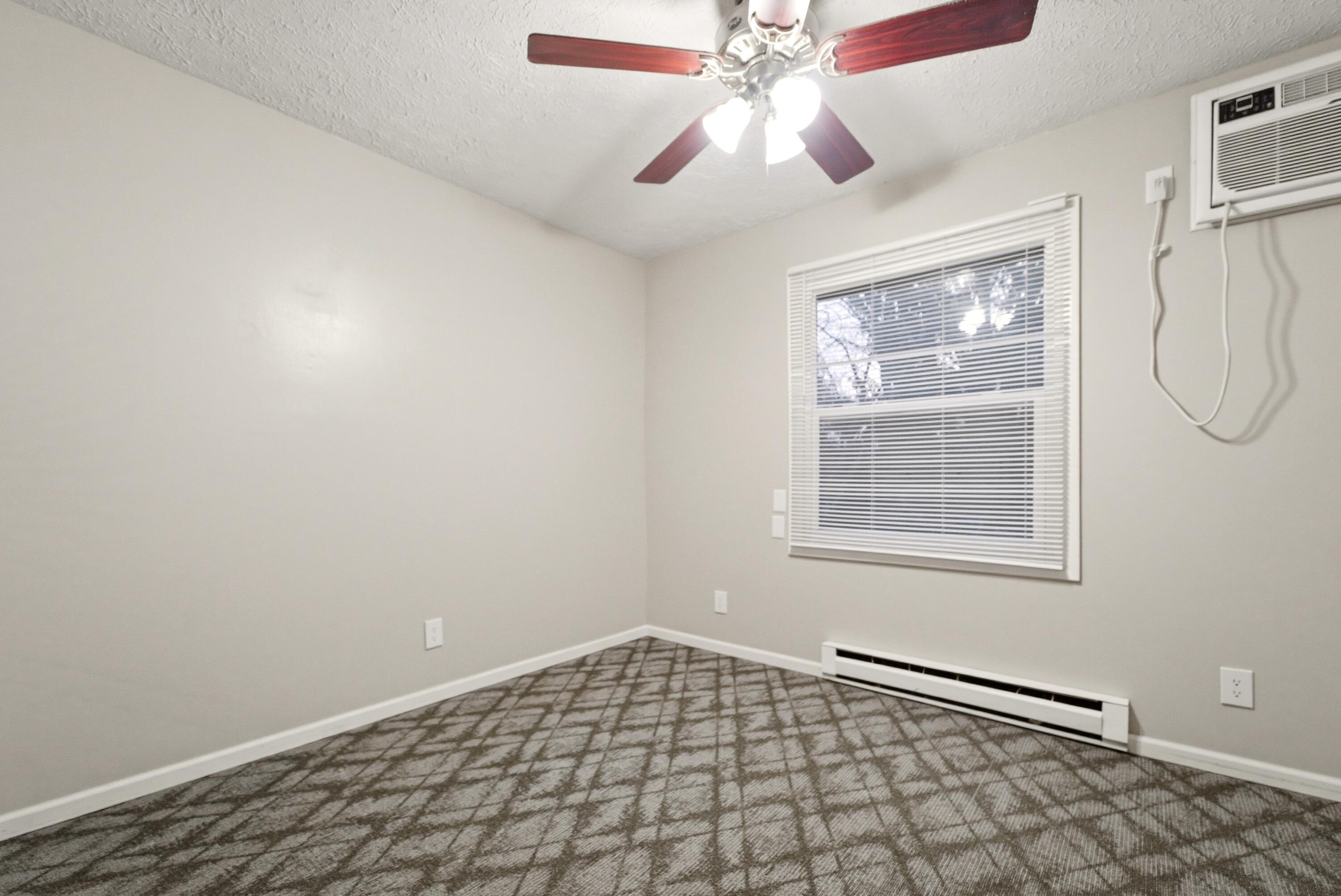 140 Sycamore Court, Unit 142 Hebron, IN 46341 - Photo 8 of 11 an empty room with windows and fan