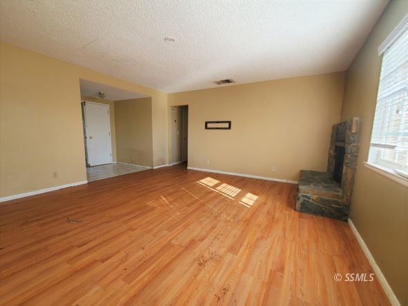 548 South Fairview Street Ridgecrest, CA 93555 - Photo 4 of 35 a view of empty room with wooden floor and fan