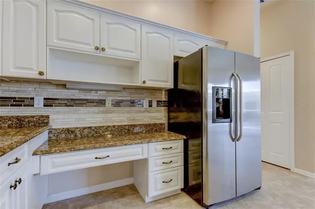 an empty room with a chandelier fan