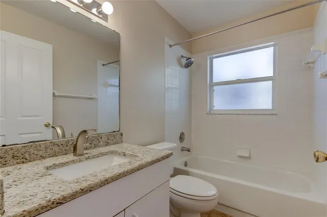 a view of a livingroom with a ceiling fan and window