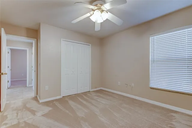 an empty room with a empty space and a ceiling fan