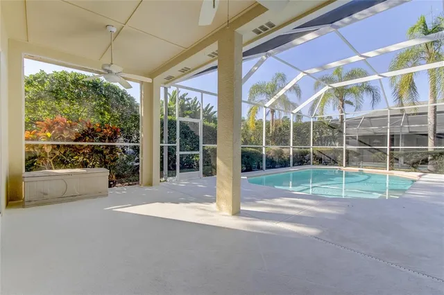 a view of a swimming pool with a yard and trees