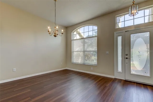 a view of a livingroom with wooden floor and a large window
