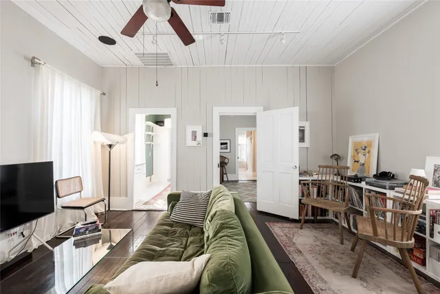a bedroom with furniture and a flat screen tv